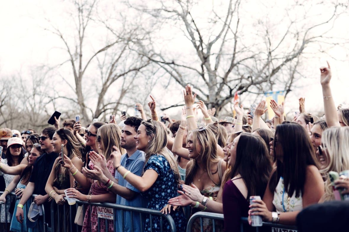 The front row along the barricade, faces lit in daylight under bare Georgia trees.